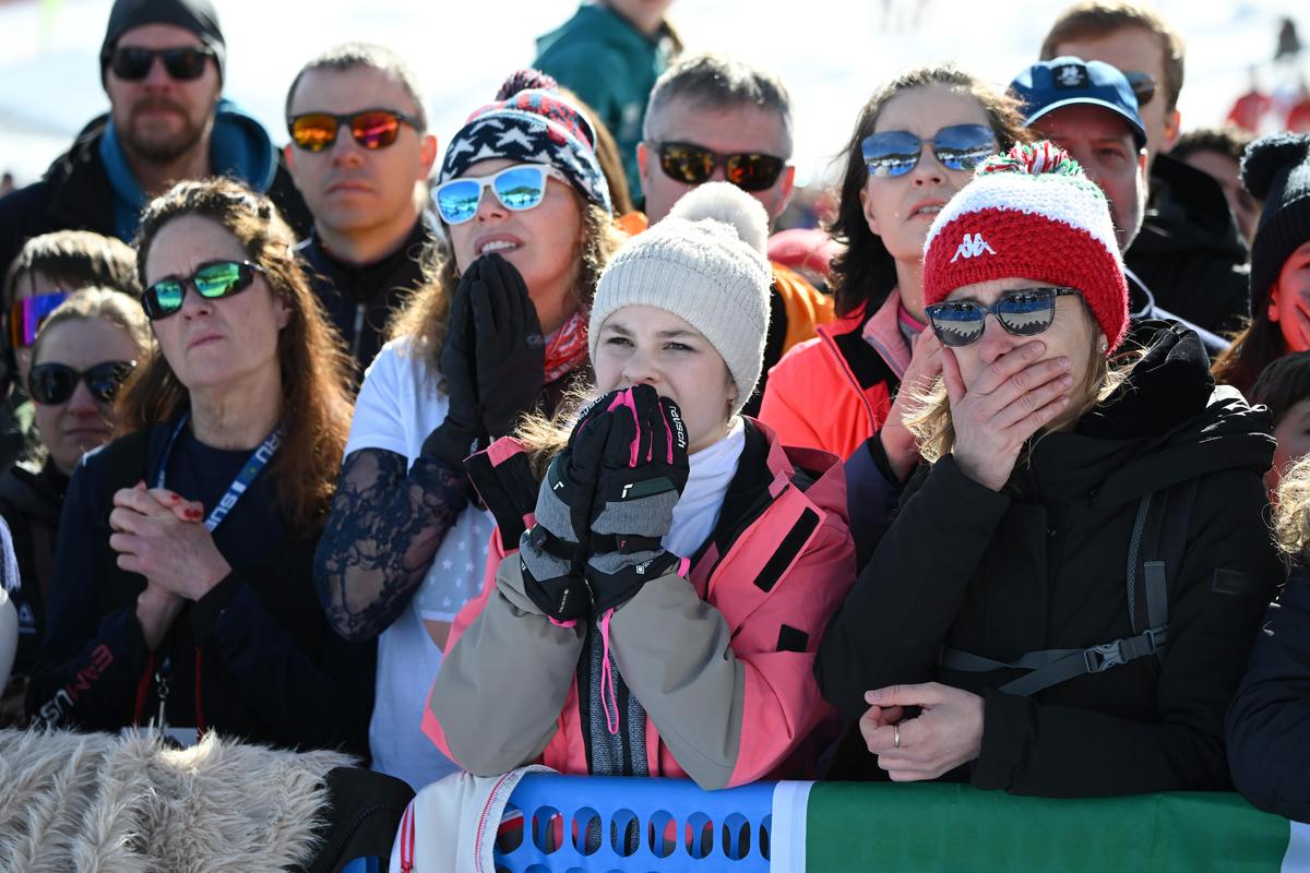 Fans react after watching Lindsey Vonn of Team United States crash on her run, on a big screen at the finish line during the Women's Downhill on day two of the Milano Cortina 2026 Winter Olympics at Tofane Alpine Skiing Centre in Cortina d'Ampezzo, Italy, on Feb. 8, 2026. (Mattia Ozbot/Getty Images)
