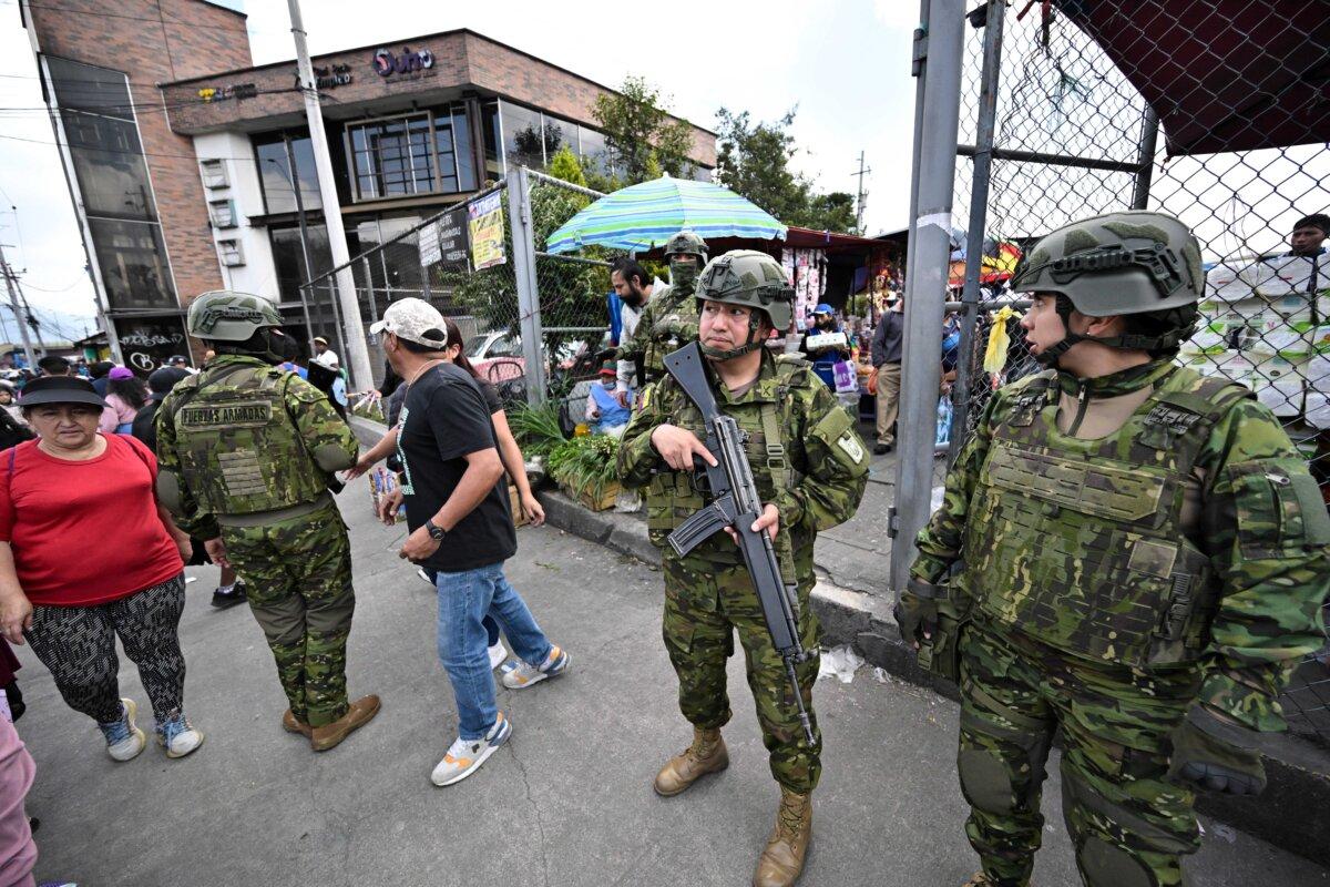 Military personnel patrol a market as they carry out weapons and drug checks in Quito, Ecuador, on Feb. 10, 2026. (Rodrigo Buendia/AFP via Getty Images)