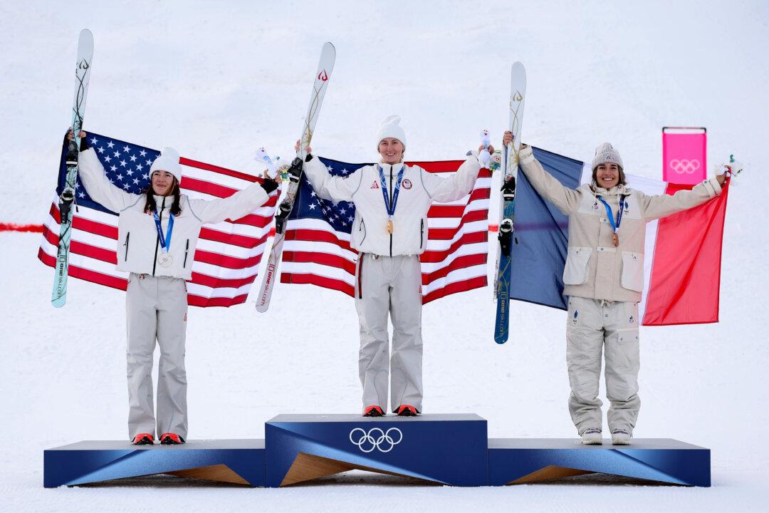 LIVIGNO, ITALY - FEBRUARY 11: Gold medalist Elizabeth Lemley of Team United States, Silver medalist Jaelin Kauf of Team United States and Bronze medalist Perrine Laffont of Team France pose for a photo with their national flags during the medal ceremony for the Women’s Freestyle Ski Moguls on day five of the Milano Cortina 2026 Winter Olympic games at Livigno Air Park on February 11, 2026 in Livigno, Italy. (Photo by Michael Reaves/Getty Images)