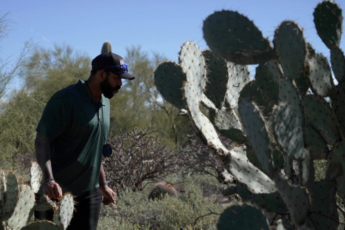 Law enforcement agents check vegetation areas around Nancy Guthrie’s home in Tucson, Ariz., on Feb. 11, 2026. (Ty ONeil/AP Photo)