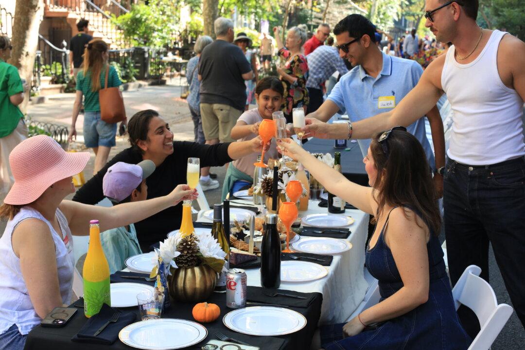 The Longest Table’s 2025 event in the Chelsea neighborhood of New York City on Oct. 5, 2025. Since launching in 2022, the gathering has grown to include hundreds, and now thousands, of neighbors. Organizer Maryam Banikarim and her nonprofit, New York City Next, provide tables and chairs while residents bring food for a large-scale potluck. (Courtesy of Mark Walker/The Longest Table)