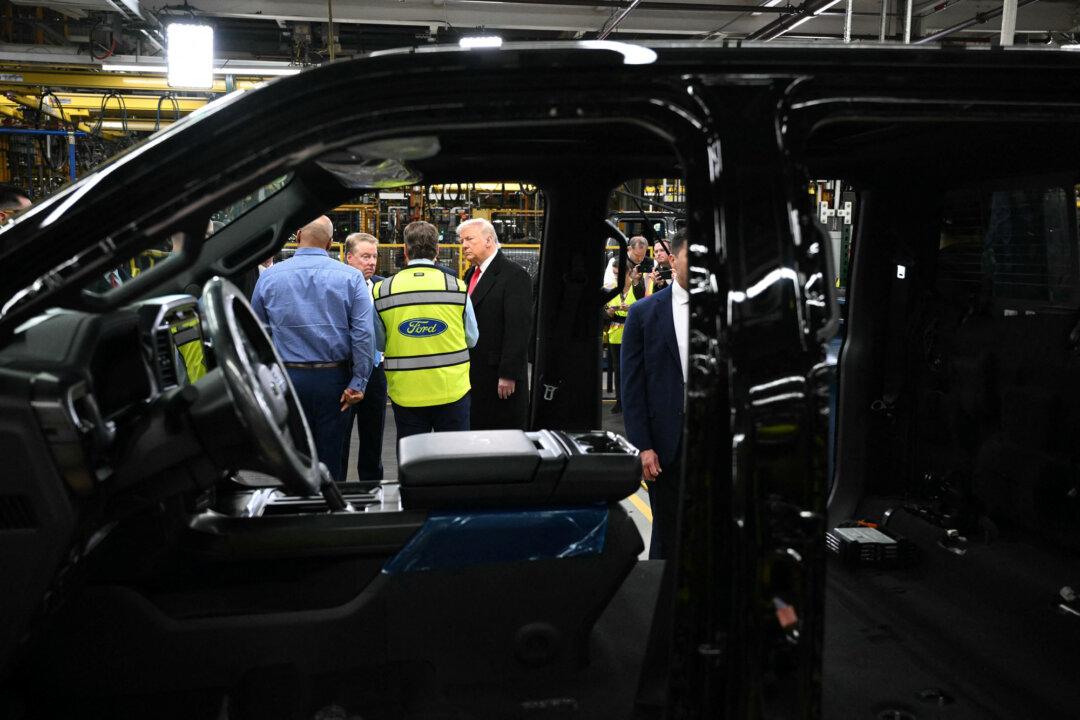 President Donald Trump speaks with Ford CEO Jim Farley (2nd R), Ford Executive Chairman Bill Ford (2nd L), and Plant Manager Corey Williams (L) as he tours Ford Motor Company’s River Rouge complex in Dearborn, Mich., on Jan. 13, 2026. (Mandel Ngan/AFP via Getty Images)