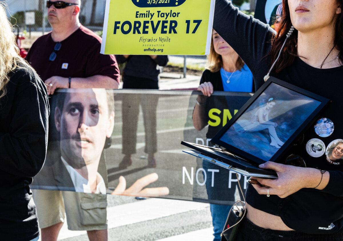 Parents who blame social media platform Snapchat for contributing to their loved one's deaths display a photo of Snap Inc. CEO Evan Spiegel, near the offices of Snap Inc., in Santa Monica, Calif., on Feb. 12, 2026. (John Fredricks/The Epoch Times)