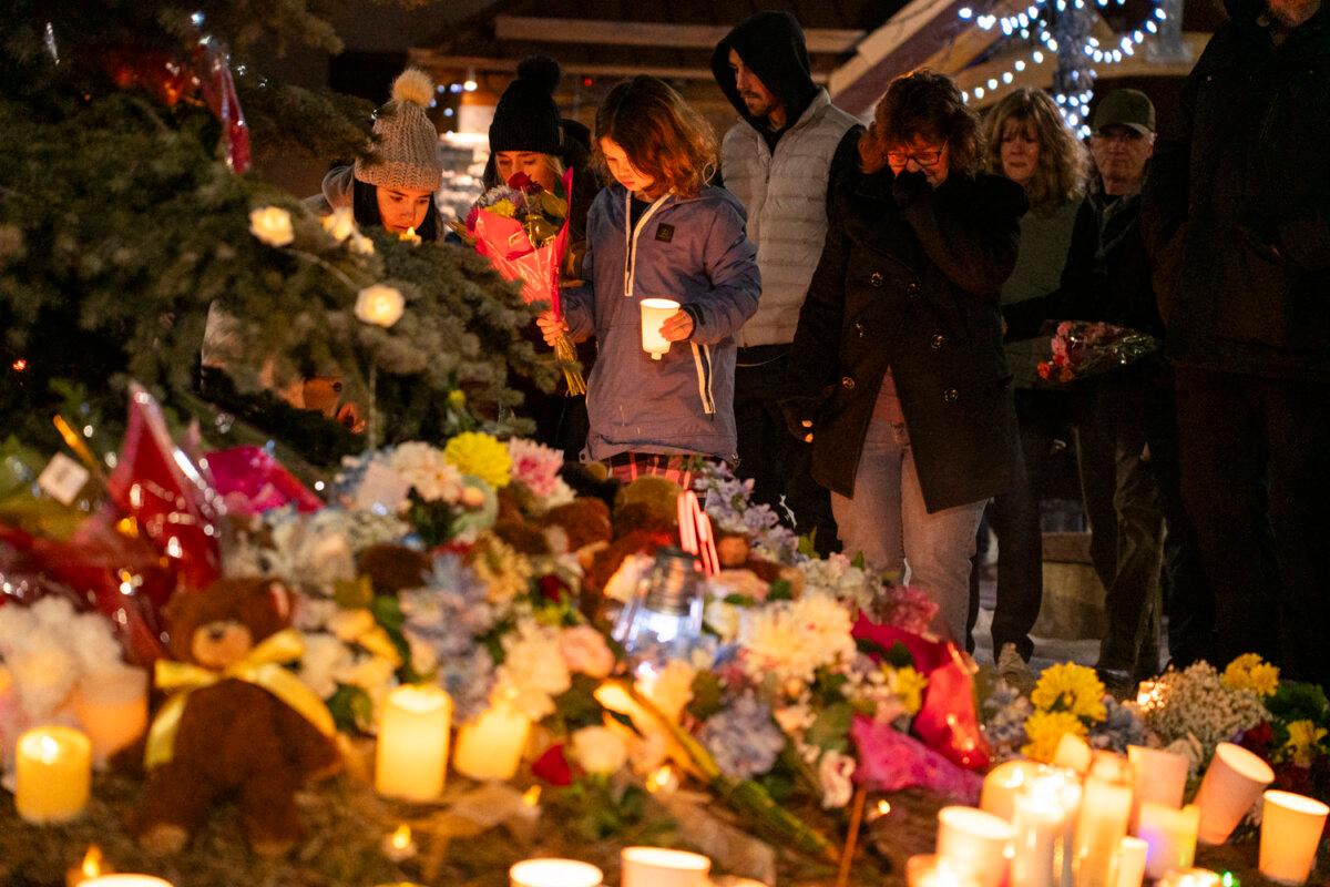 Community members mourn during a candlelight vigil for the victims of Tumbler Ridge Secondary School where a mass shooting took place a day earlier in the small town of Tumbler Ridge, B.C. on Feb. 11, 2026. (Paige Taylor White / AFP via Getty Images)