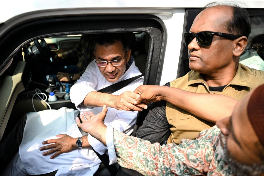 TOPSHOT - Bangladesh Nationalist Party (BNP) chairman and election candidate Tarique Rahman (L) greets his supporters as leaves his residence in Dhaka on February 13, 2026 a day after Bangladesh's general election. The Bangladesh Nationalist Party (BNP) claimed a thumping win on February 13 in the first elections held since a deadly 2024 uprising, with leader Tarique Rahman poised to become prime minister. (Photo by MUNIR UZ ZAMAN / AFP via Getty Images)