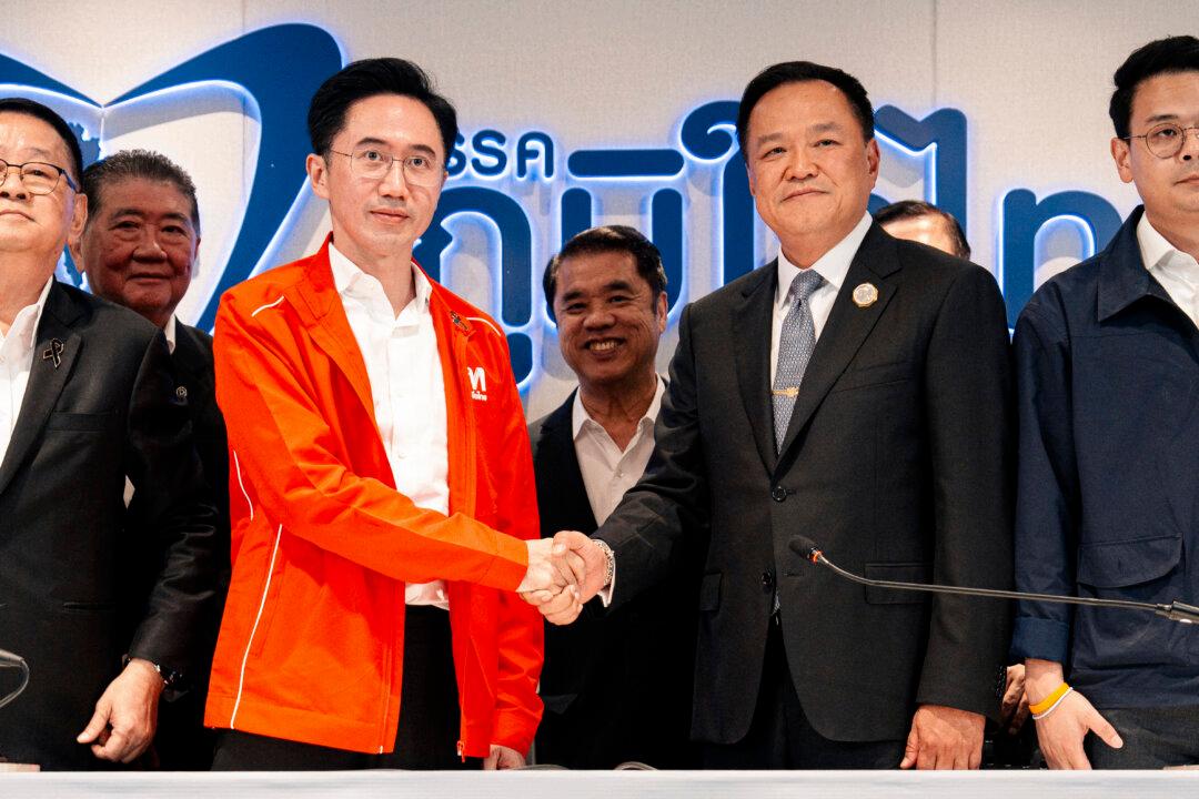 Thailand's caretaker Prime Minister Anutin Charnvirakul (centre R), leader of the Bhumjaithai party, shakes hands with the Pheu Thai Party's prime ministerial candidate Yodchanan Wongsawat (centre L) during a meeting at the Bhumjaithai headquarters in Bangkok on February 13, 2026. Thailand's caretaker Prime Minister Anutin Charnvirakul said February 13 that his Bhumjaithai party, which won the election at the weekend, agreed to form a coalition with jailed Thai ex-premier Thaksin Shinawatra's party. (Photo by Arnun Chonmahatrakool / THAI NEWS PIX / AFP via Getty Images)