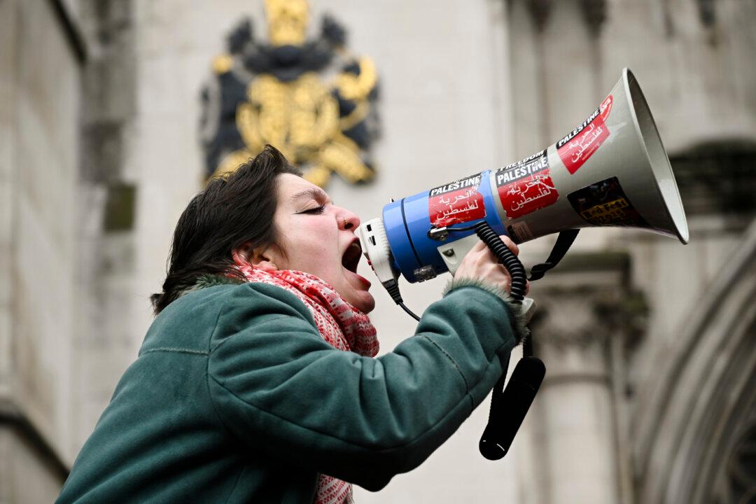 LONDON, ENGLAND - FEBRUARY 13: Demonstrators gather outside the High Court during a ruling on whether the government's ban of Palestine Action was unlawful on February 13, 2026 in London, United Kingdom. The High Court has ruled that the government's ban of Palestine Action was unlawful. The ban, which took effect July 5 last year, made membership in or support for the direct-action group a criminal offence punishable by up to 14 years in prison. The move drew widespread condemnation and triggered protests during which more than 2,000 people were arrested. (Photo by Ben Montgomery/Getty Images)