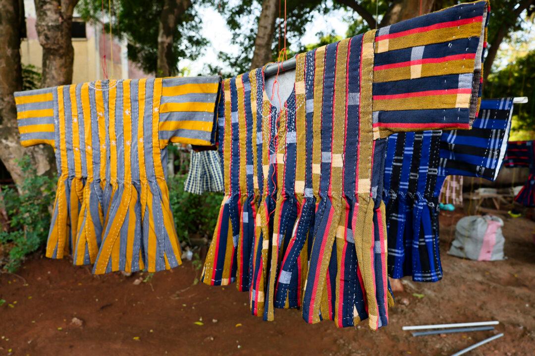 Traditional garments, known as a 'fugu', are displayed for sale on a street in Accra on February 13, 2026. The colorful woven traditional blouse originating from northern Ghana, known as the fugu, smock or batakari, worn by both men and women, is seeing renewed interest after the government declared Wednesdays 'Fugu Day'.
The initiative follows an official trip in early February by Ghanaian President John Mahama to Zambia, during which his outfit a loose blue-and-grey striped fugu sparked mockery online, with some users deeming it inappropriate attire for a head of state. (Photo by Nipah Dennis / AFP via Getty Images)