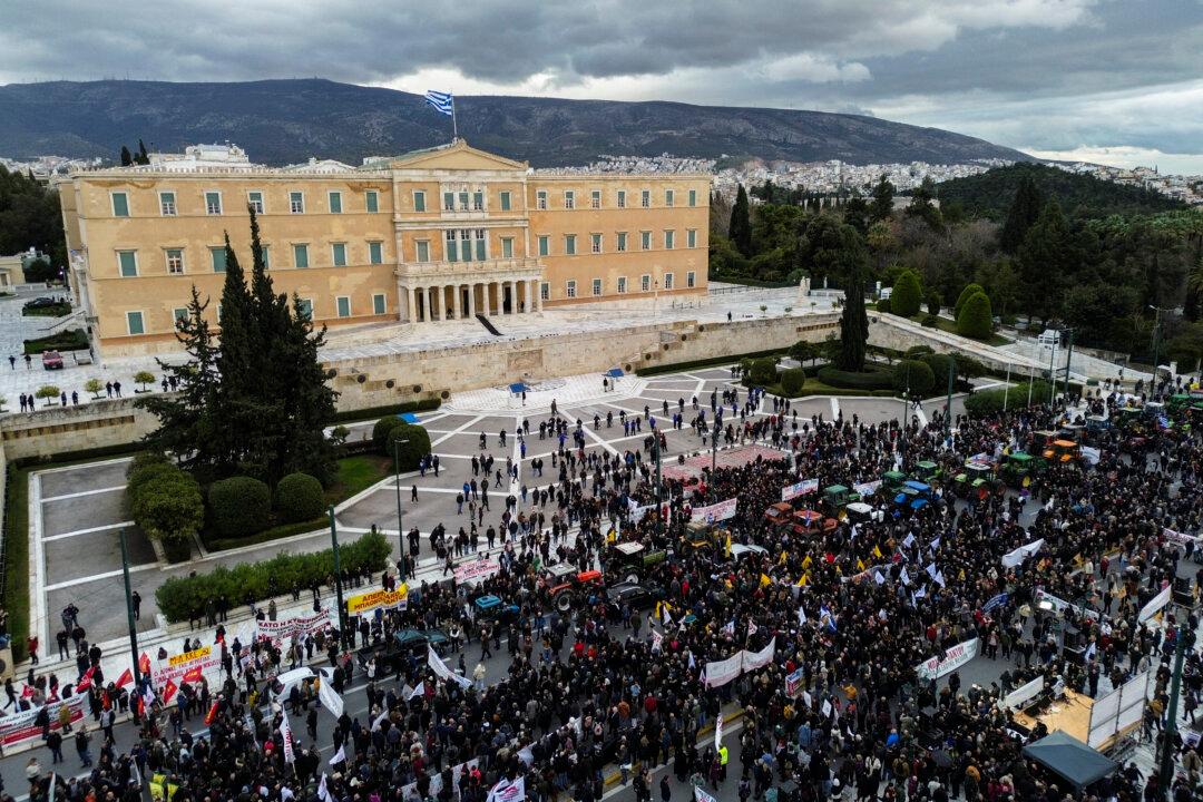 TOPSHOT - This aerial picture shows Greek farmers protesting with tractors outside the Greek parliament during a demonstration in Athens on February 13, 2026. (Photo by Aris MESSINIS / AFP via Getty Images)