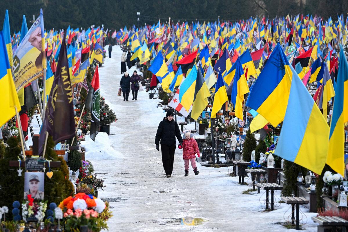 Mourners walk on Valentine's Day at the Lychakiv Military Cemetery in Lviv, Ukraine, on Feb. 14, 2026. (Yuriy Dyachyshyn/ AFP via Getty Images)