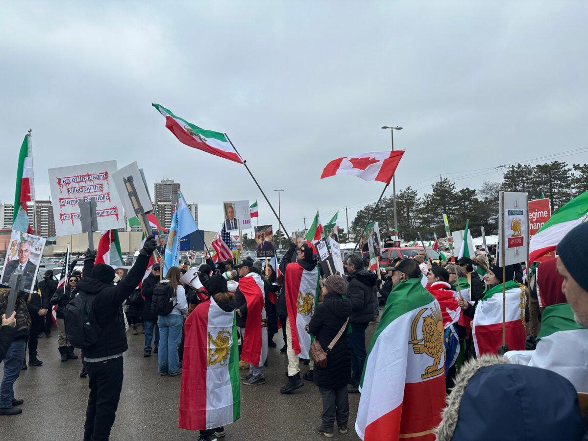 Demonstrators demanding regime change in Iran, holding pre-1979 revolution Iranian national flags and Canadian flags, protest in Toronto on Feb. 14, 2026. (The Epoch Times)
