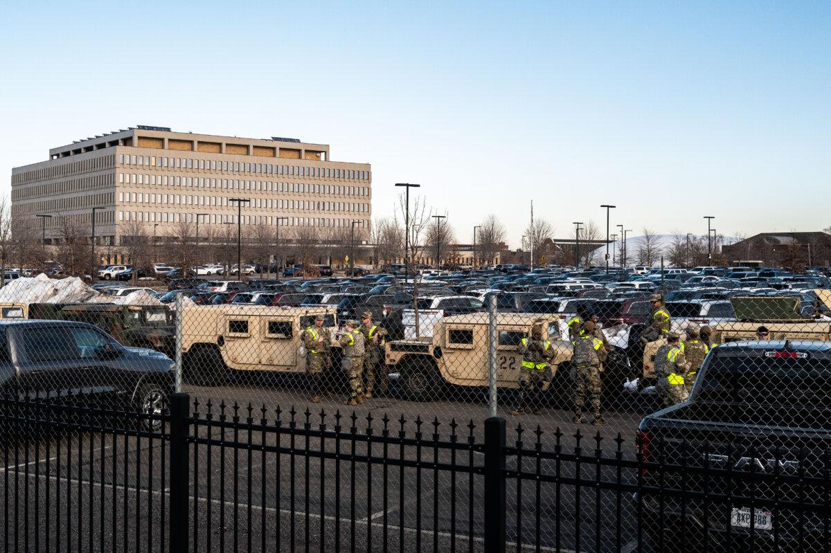 Members of the Minnesota National Guard stage in the parking lot outside the Bishop Henry Whipple Federal Building in Minneapolis on Feb. 13, 2026. (Stephen Maturen/Getty Images)