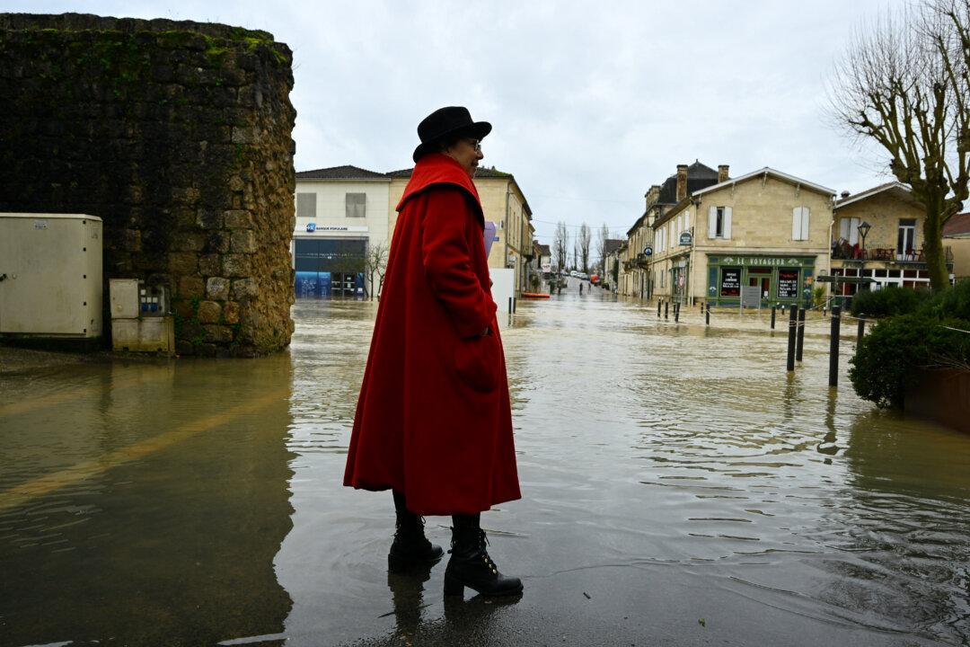 Minister for Ecological Transition and Biodiversity Monique Barbut stands in a flooded street as she visits Cadillac-sur-Garonne, southwestern France, on February 16, 2026. The flood alert system in France has been working at a record pace as relentless rain over the past month has saturated soils, the head of the agency told AFP on February 14, 2026. "For 30 days we have been in continuous orange or red alert somewhere on the national territory," Lucie Chadourne-Facon, director of Vigicrues, told AFP, referring to the two highest alert levels. (Photo by Gaizka IROZ / AFP via Getty Images)