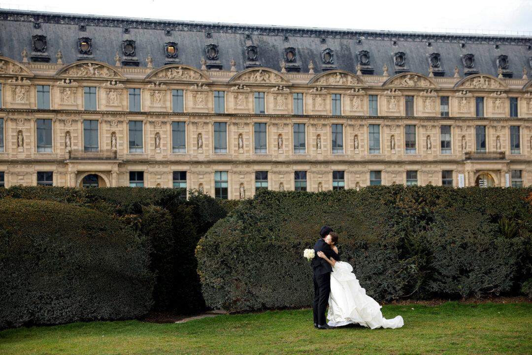 A newlywed couple embraces at the Jardin des Tuileries, central Paris on February 16, 2026. (Photo by Charlotte SIEMON / AFP via Getty Images)