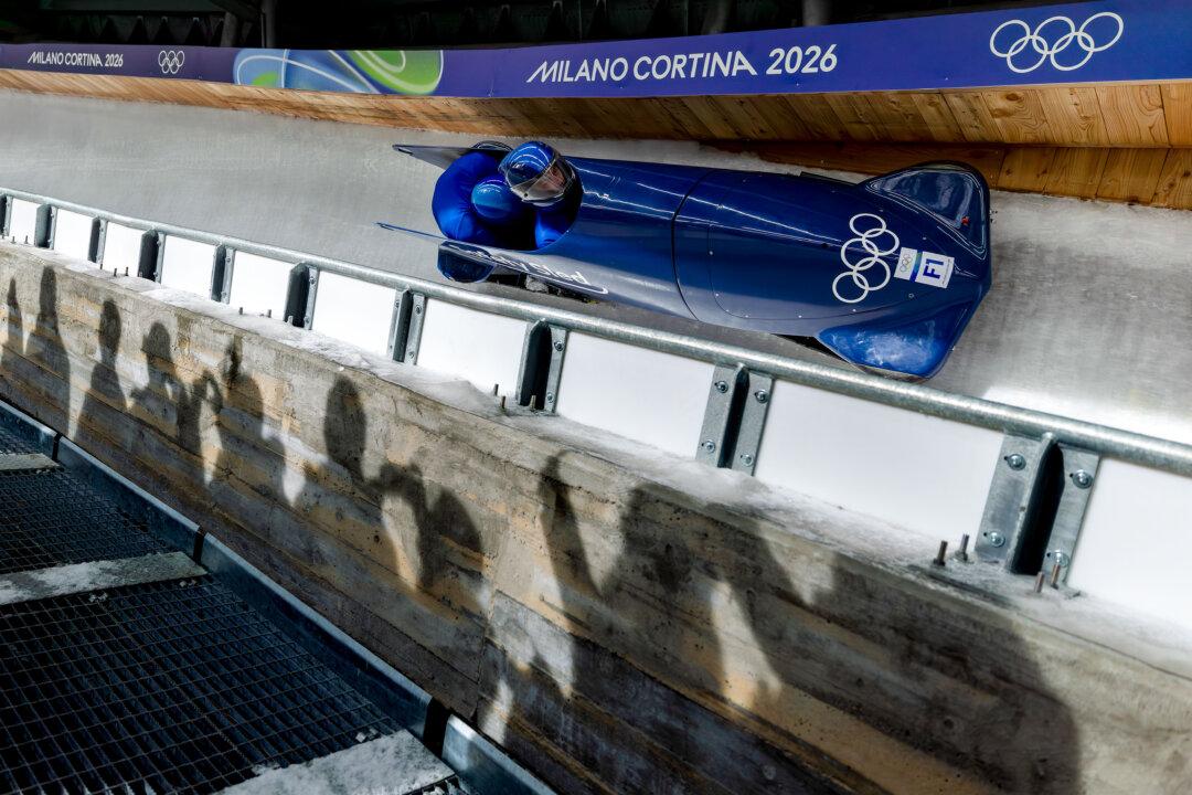 CORTINA D'AMPEZZO, ITALY - FEBRUARY 16: A forerunner pilots prior to the Men's Two-Man Bobsleigh Heat 2 on day ten of the Milano Cortina 2026 Winter Olympic games at Cortina Sliding Centre on February 16, 2026 in Cortina d'Ampezzo, Italy. (Photo by Al Bello/Getty Images)