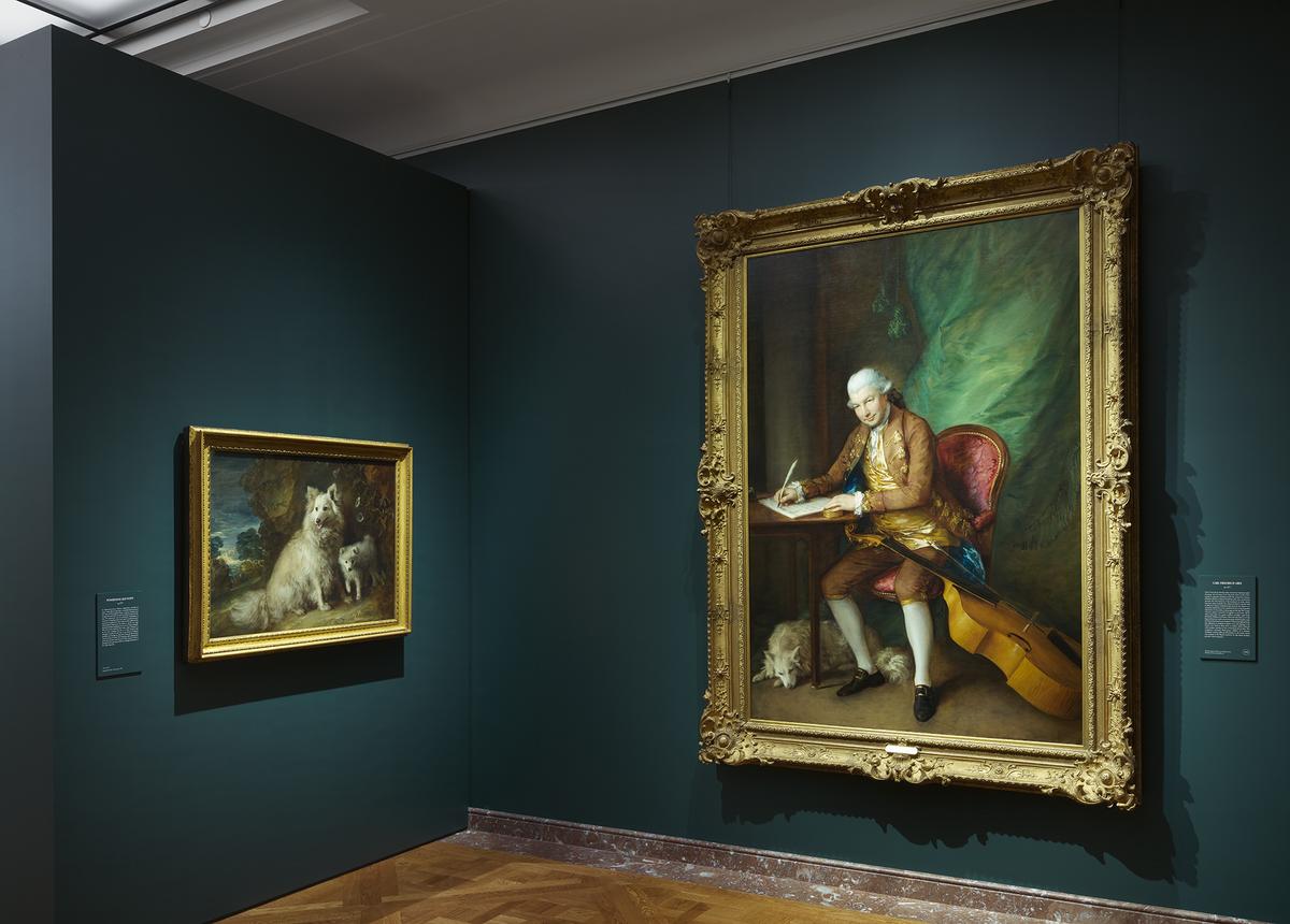 Installation view of "Gainsborough: The Fashion of Portraiture" with paintings (left) "Pomeranian and Puppy" and "Carl Friedrich Abel," circa 1777, at The Frick Collection in New York City. (Courtesy of The Frick Collection)