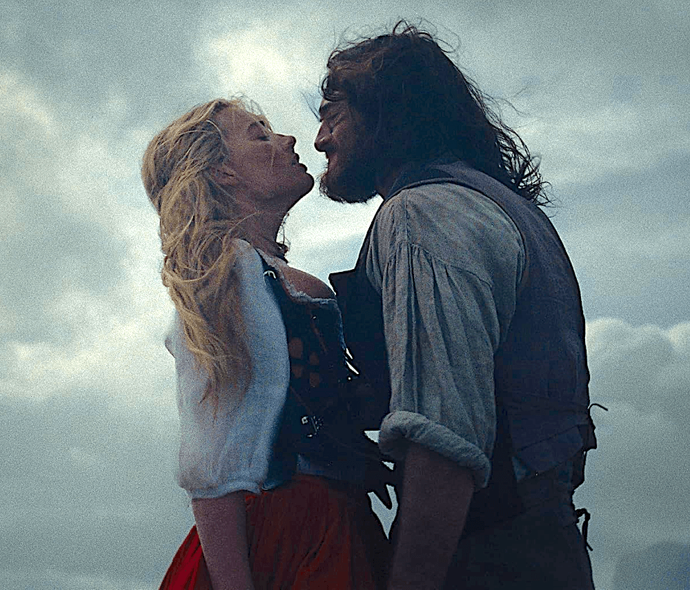 Cathy (Margot Robbie) and Heathcliff (Jacob Elordi) in danger of great sin, in "Wuthering Heights." (Warner Bros. Pictures)