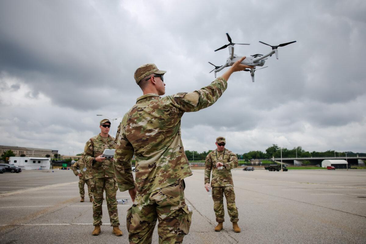 A U.S. soldier holds a drone in the Pentagon parking lot in Arlington, Va., on June 14, 2025. (Samuel Corum/Getty Images)