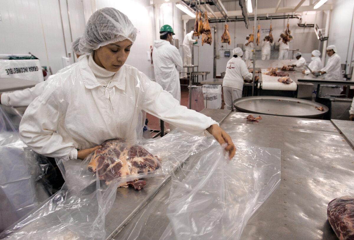 Workers make and wrap beef cuts for export at a meat processing plant in Buenos Aires, in this file photo. (Daniel Garcia/AFP via Getty Images)