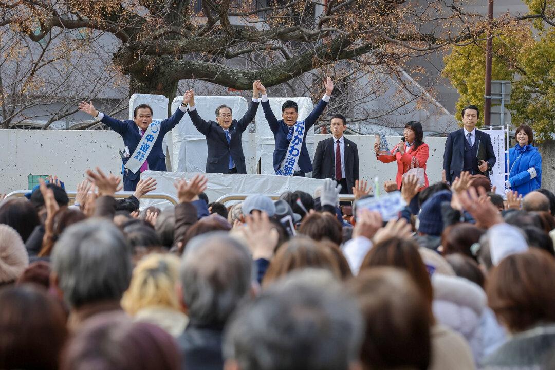 Tetsuo Saito (C), leader of the Komeito party, holds hands with his party’s candidates after delivering a speech during an election campaign rally in Kobe, Japan, on Jan. 27, 2026. Komeito—the Liberal Democratic Party’s longtime junior coalition partner that often acted as a moderating force—left the coalition in October 2025. (Buddhika Weerasinghe/Getty Images)