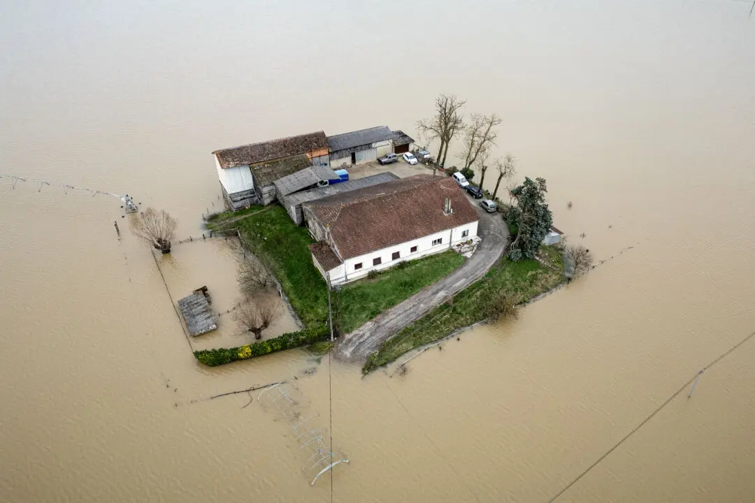 Day in Photos: Floods in France, Supreme Court Tariff Ruling, and Danish King Visits Greenland