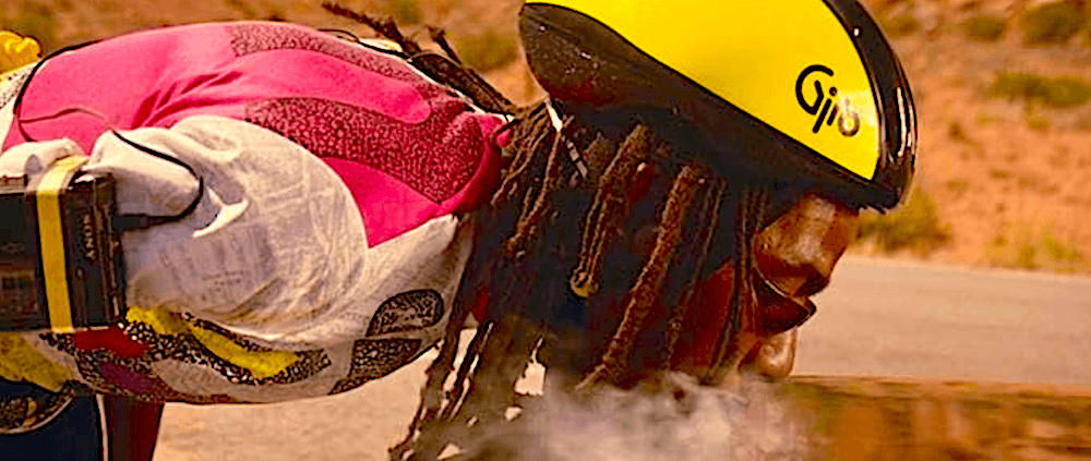 Rastafarian bicyclist (Noel L. Walcott) blows some weed-smoke in one of Thelma's gunshot trunk-air holes, in “Thelma & Louise.” (MGM)