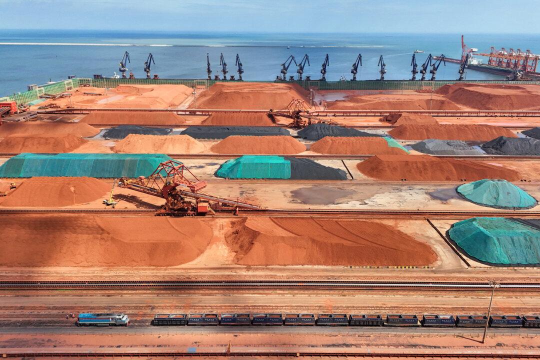 Imported iron ore, bauxite, and coal are stored at Yantai Port in Shandong Province, China, on July 25, 2025. Many natural resource-rich countries are imposing export controls and seeking to encourage in-country processing rather than shipping their raw materials to China for refining. (STR/AFP via Getty Images)