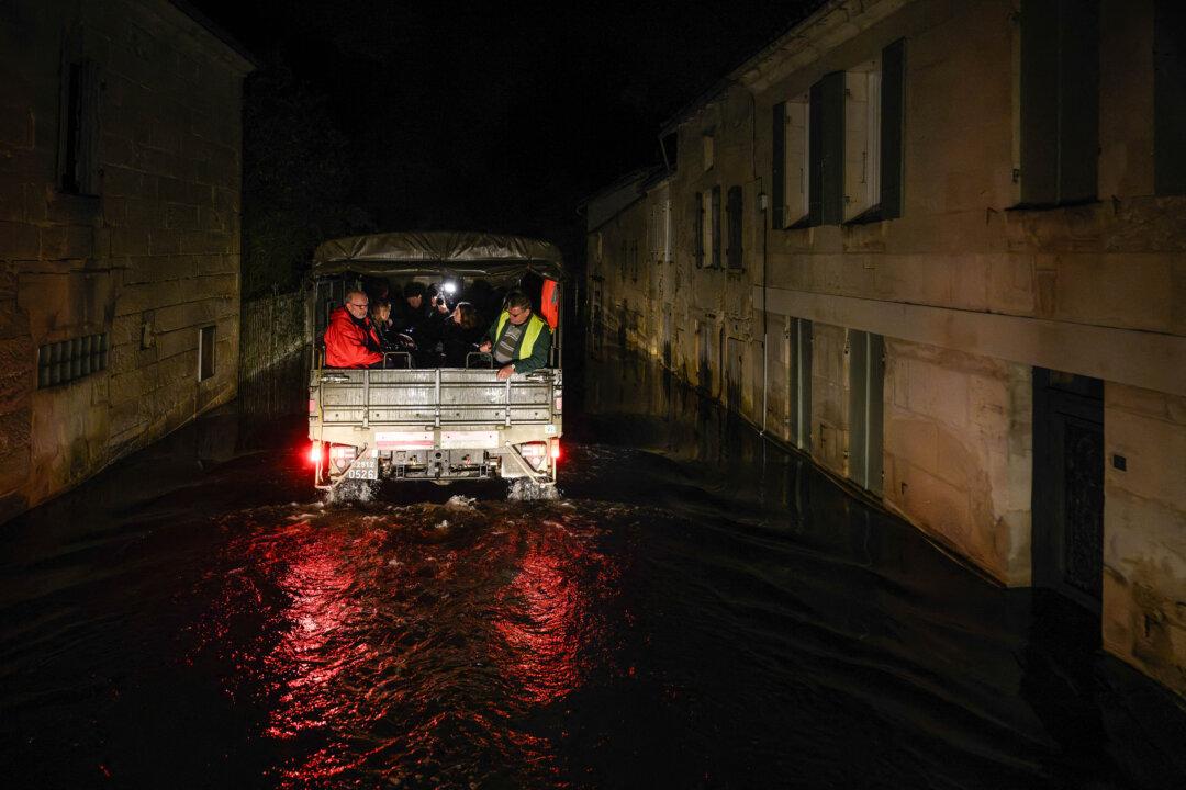 A French gendarmerie 4x4 vehicle transporting residents drives in the flood-isolated village of Courcoury, south-western France on February 23, 2026, towards neighboring Courpignac as the Charente-Maritime commune remains surrounded by floodwaters following storm Nils. (Photo by Philippe LOPEZ / AFP via Getty Images)
