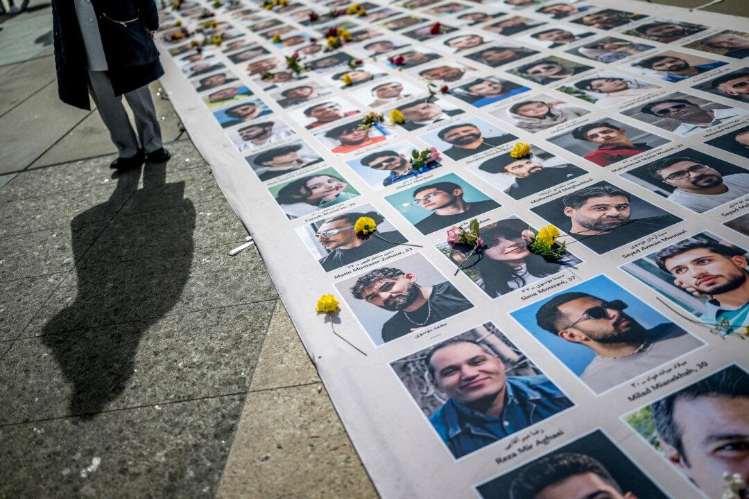 Portraits of killed Iranian protesters are displayed during a demonstration against the Iranian regime on the sideline of the 61st session of the UN Human Rights Council in Geneva on February 23, 2026. (Photo by Fabrice COFFRINI / AFP via Getty Images)