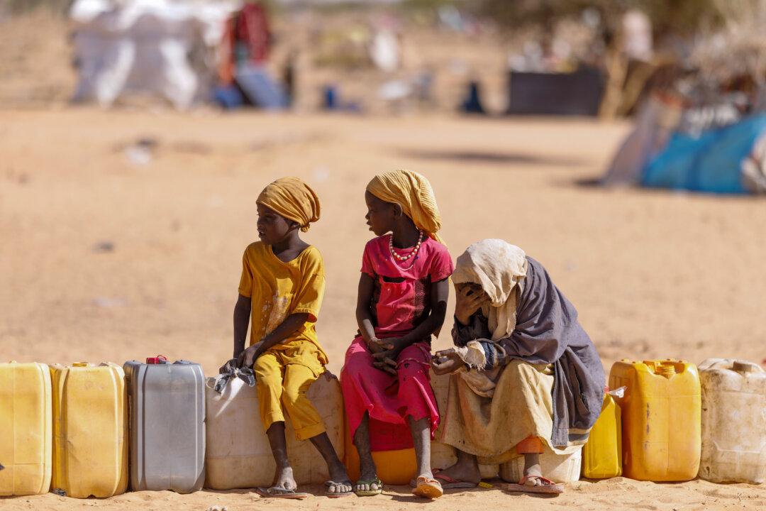 OURE CASSONI, CHAD - FEBRUARY 23: Children wait for water at the Oure Cassoni refugee camp after arriving from Sudan, on February 23, 2026 in Oure Cassoni, Chad. In April 2023 civil war erupted between the Sudanese Armed Forces (SAF) and the armed militia group Rapid Support Forces (RSF). The ongoing conflict has so far displaced around 14 million people across the region, triggering a widespread humanitarian crisis, as neighboring countries like Chad struggle to absorb refugees, while coping with populations already suffering high poverty rates and food insecurity. Chad has become Africa's largest host of refugees per capita, hosting a total 1.4 million refugees - more than 900,000 of which fled the conflict in Sudan. The most recent wave of arrivals from Sudan follows the RSF's offensive to capture the north Darfur city of El Fasher, where 6,000 people were reportedly killed by the RSF in the space of three days in October. A recent UN report has accused the RSF of atrocities that amount to war crimes and possible crimes against humanity. As many as 400,000 people have reportedly been killed since the conflict began. (Photo by Dan Kitwood/Getty Images)
