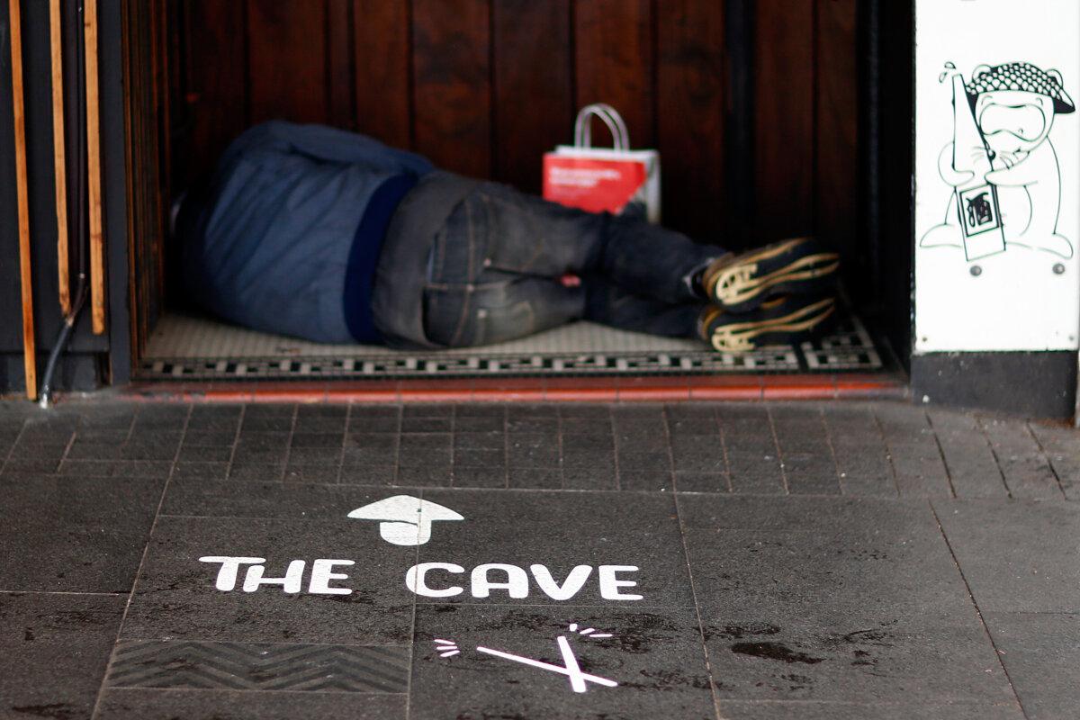 A homeless person sleeps in a doorway in the Auckland CBD in Auckland, New Zealand, on July 13, 2017. (Phil Walter/Getty Images)