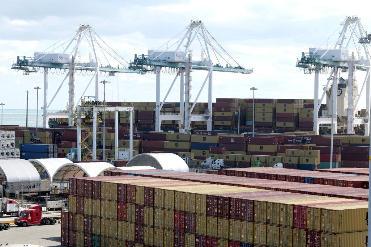 Shipping containers are stacked at PortMiami as workers handle cargo in Miami, Fla., on Jan. 20, 2026. (Joe Raedle/Getty Images)