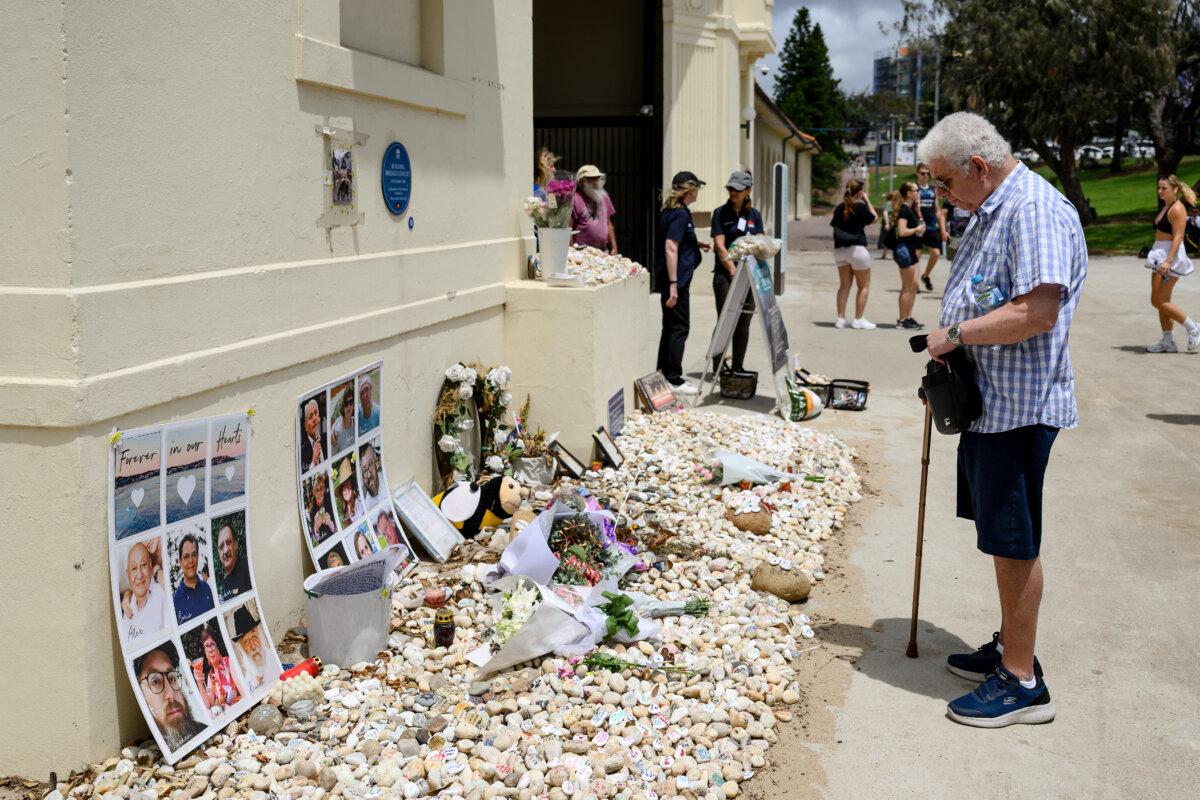 A man reads tributes in memory of the victims of Dec. 14 Bondi Beach shooting in Sydney, Australia, on Jan. 22, 2026. (Steven Markham / AFP via Getty Images)