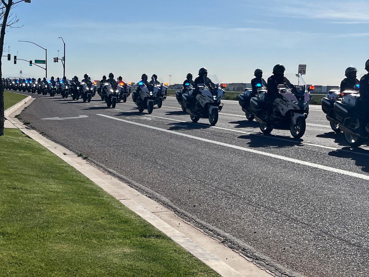 A law enforcement motorcade featuring members of multiple departments enters the Mission Church in Gilbert, Ariz., on Feb. 4. (Allan Stein/The Epoch Times)