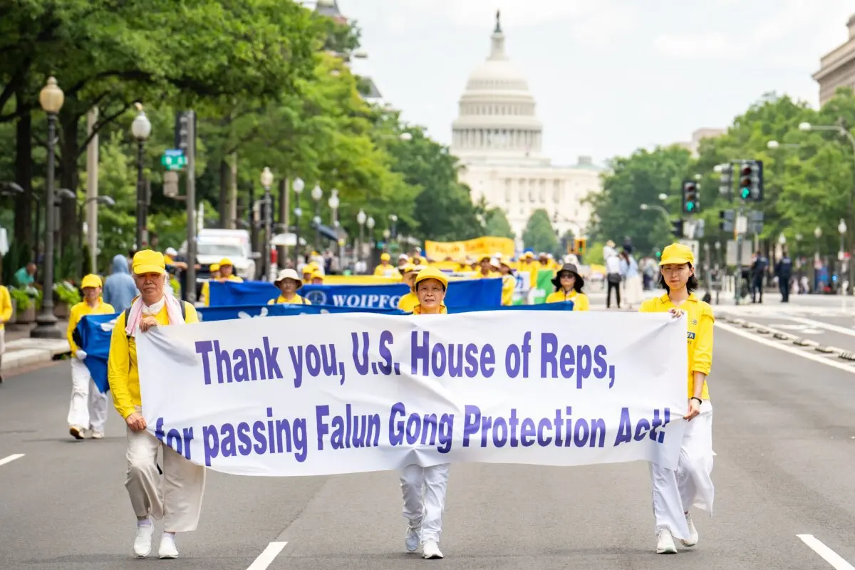Falun Dafa practitioners take part in a march calling for the end of the Chinese Communist Party's 26 years of persecution of Falun Gong in China, in Washington on July 17, 2025. (Samira Bouaou/The Epoch Times)