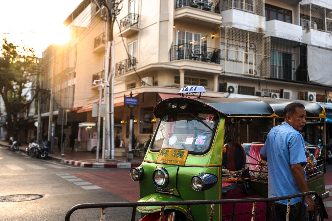 A tuk tuk driver stands beside his vehicle in Bangkok on February 24, 2026. (Photo by chanakarn laosarakham / AFP via Getty Images)