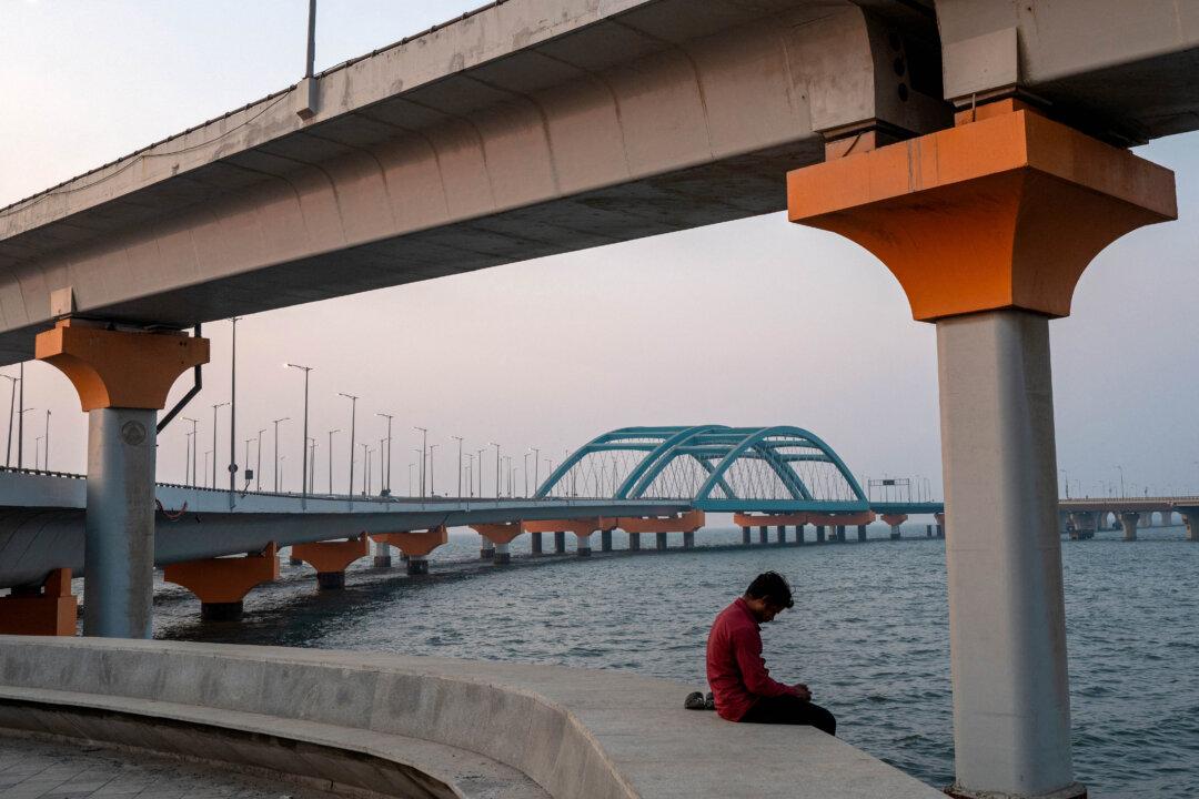 TOPSHOT - A man sits at the seafront during sunset in Mumbai on February 24, 2026. (Photo by Punit PARANJPE / AFP via Getty Images)