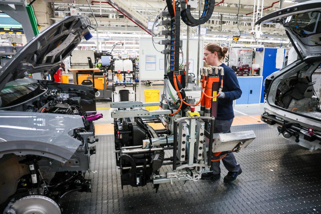 EMDEN, GERMANY - FEBRUARY 24: Volkswagen assembly worker Jasmin Artmann attaches the front panel to an ID line electric car at the Volkswagen electric car factory on February 24, 2026 in Emden, Germany. Volkswagen rose in 2025 to first place in electric car sales in Europe, beating out rival Tesla. (Photo by Focke Strangmann/Getty Images)