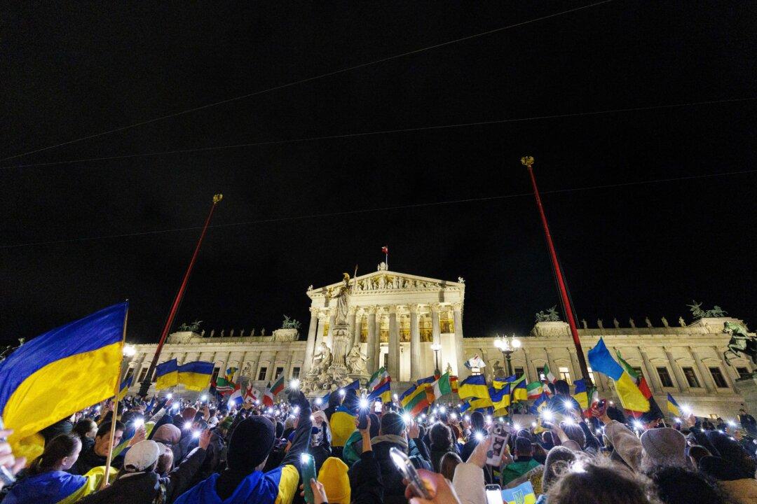 People take part in a rally to mark 4th anniversary of the Russian full scale invasion on Ukraine on February 24, 2026 in front of the Austrian Parliament in Vienna. (Photo by TOBIAS STEINMAURER / APA / AFP via Getty Images) / Austria OUT