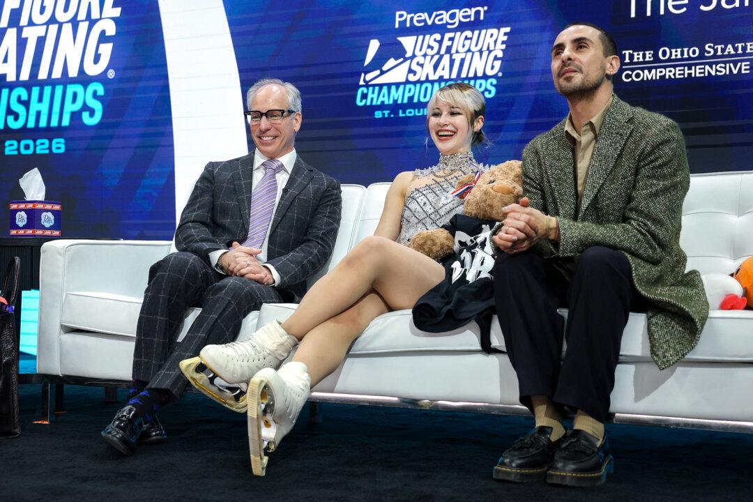 Alysa Liu celebrates in the Kiss and Cry with her coaches Phillip DiGuglielmo and Massimo Scali after the Women’s Free Skate during the 2026 United States Figure Skating Championships in St. Louis on Jan. 9, 2026. (Matthew Stockman/Getty Images)