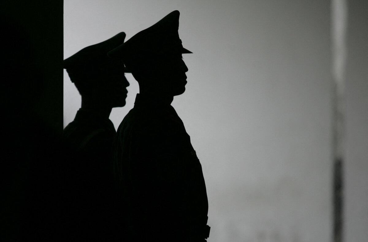 Chinese paramilitary policemen stand guard at the subway exit to Tiananmen Square on the eve of Chinese National Day on Sept. 30, 2005. (Peter Parks/AFP via Getty Images)