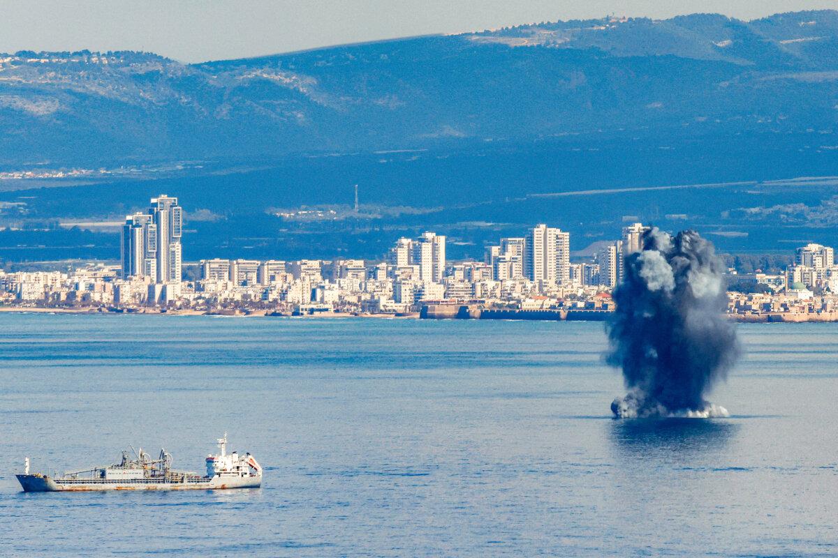 An incoming projectile explodes over the water in the bay of Haifa off of the northern Israeli coastal city, on Feb. 28, 2026. (Jalaa MAREY / AFP via Getty Images)