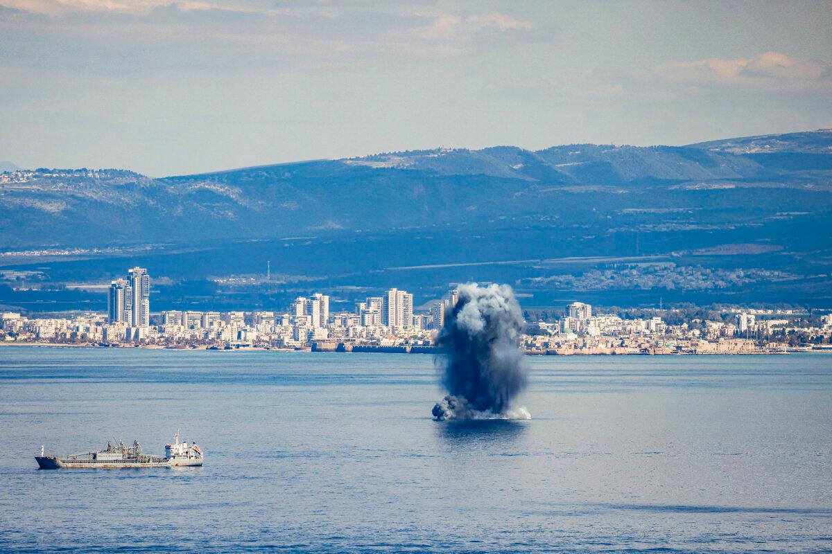 An incoming projectile explodes over the water in the bay of Haifa off of the northern Israeli coastal city on Feb. 28, 2026. (Jalaa Marey/AFP via Getty Images)