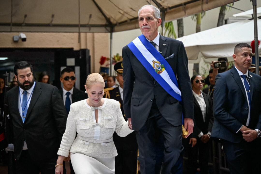 Honduran President Nasry Asfura and his wife Lissette del Cid walk onto a stage following the inauguration ceremony at the Honduran Congress, in Tegucigalpa on Jan. 27, 2026. (Johan Ordonez / AFP via Getty Images)