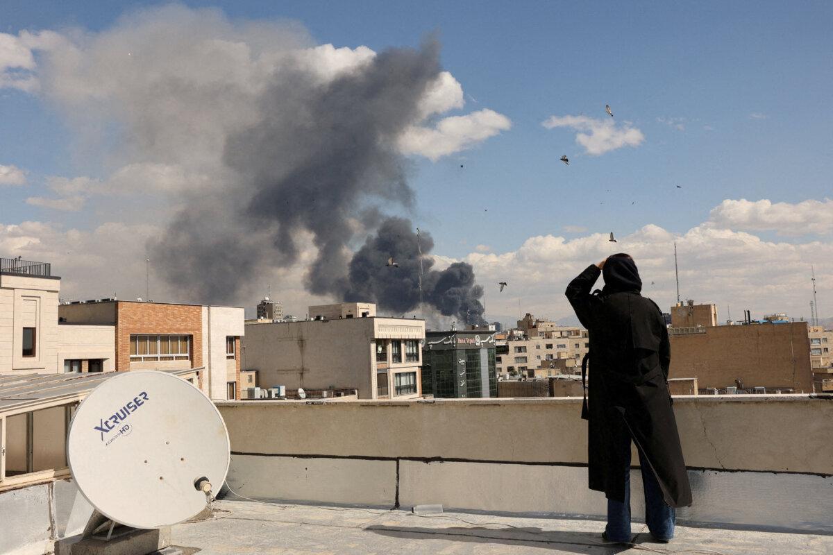 Smoke rises from an explosion after Israel and the United States launched strikes on Iran, in Tehran on March 1, 2026. (Majid Asgaripour/Wana via Reuters)