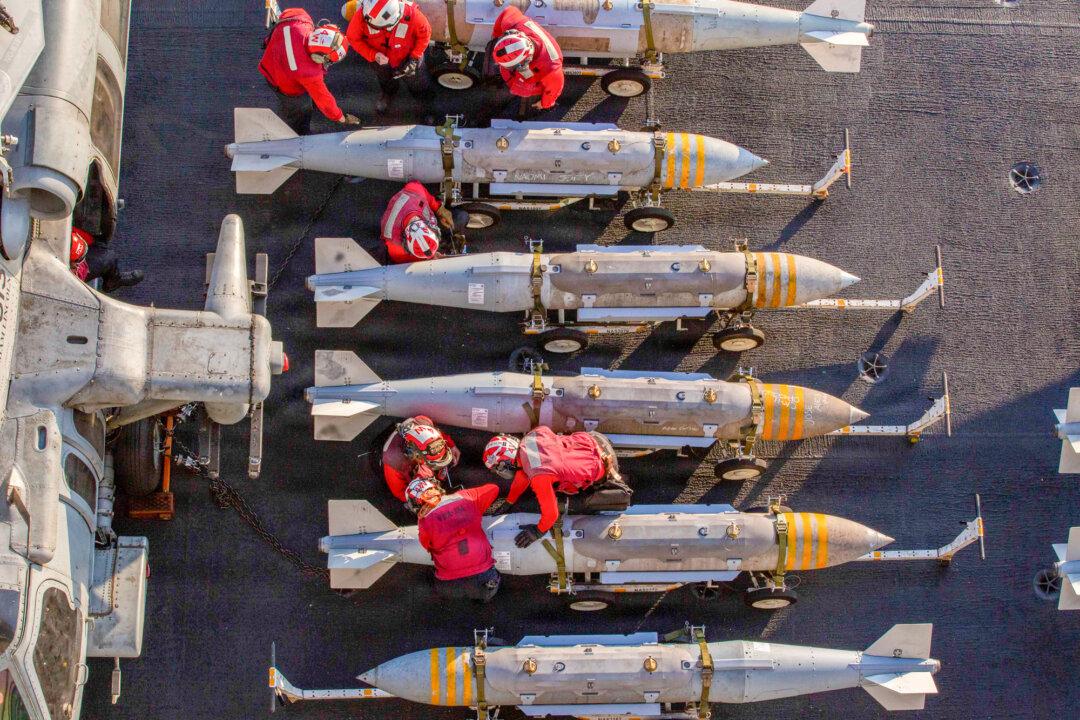 (Top) Nimitz-class aircraft carrier USS Abraham Lincoln (CVN 72), Arleigh Burke-class guided-missile destroyers USS Michael Murphy (DDG 112), USS Frank E. Petersen Jr. (DDG 121), Henry J. Kaiser-class fleet replenishment oiler USNS Henry J. Kaiser (T-AO-187), Lewis and Clark-class dry cargo ship USNS Carl Brashear (T-AKE 7), and U.S. Coast Guard Sentinel-class fast-response cutters USCG Robert Goldman (WPC-1142) and USCGC Clarence Sutphin. Jr. (WPC-1147) sail in formation in the Arabian Sea, on Feb. 6, 2026. (Bottom Left) An F/A-18E Super Hornet, attached to Strike Fighter Squadron (VFA) 14, prepares to land on the flight deck of aircraft carrier USS Abraham Lincoln (CVN 72) during Operation Epic Fury at Sea on March 1, 2026. (Bottom Right) U.S. sailors prepare to stage ordnance on the flight deck of the USS Abraham Lincoln on Feb. 28, 2026. (Mass Communication Specialist 1st Class Jesse Monford/U.S. Navy via Getty Images, U.S. Navy via Getty Images)