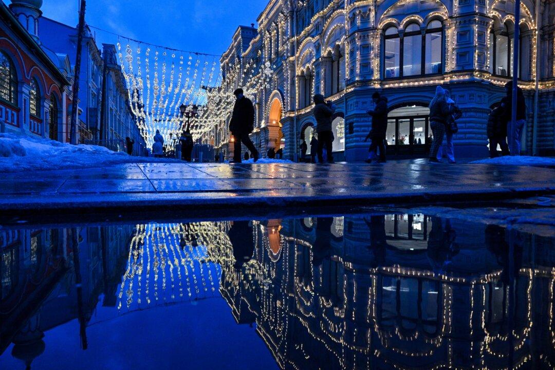People walk on a street in central Moscow, on March 5, 2026. (Photo by Hector RETAMAL / AFP via Getty Images)
