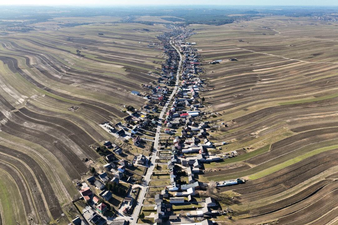 This aerial photograph taken on March 5, 2026 shows a view of Suloszowa, a village in Lesser Poland Voivodeship, southern Poland, considered to be the longest village in the country, where nearly all residents live along a winding road stretching for almost 9 kilometres. (Photo by Sergei GAPON / AFP via Getty Images)