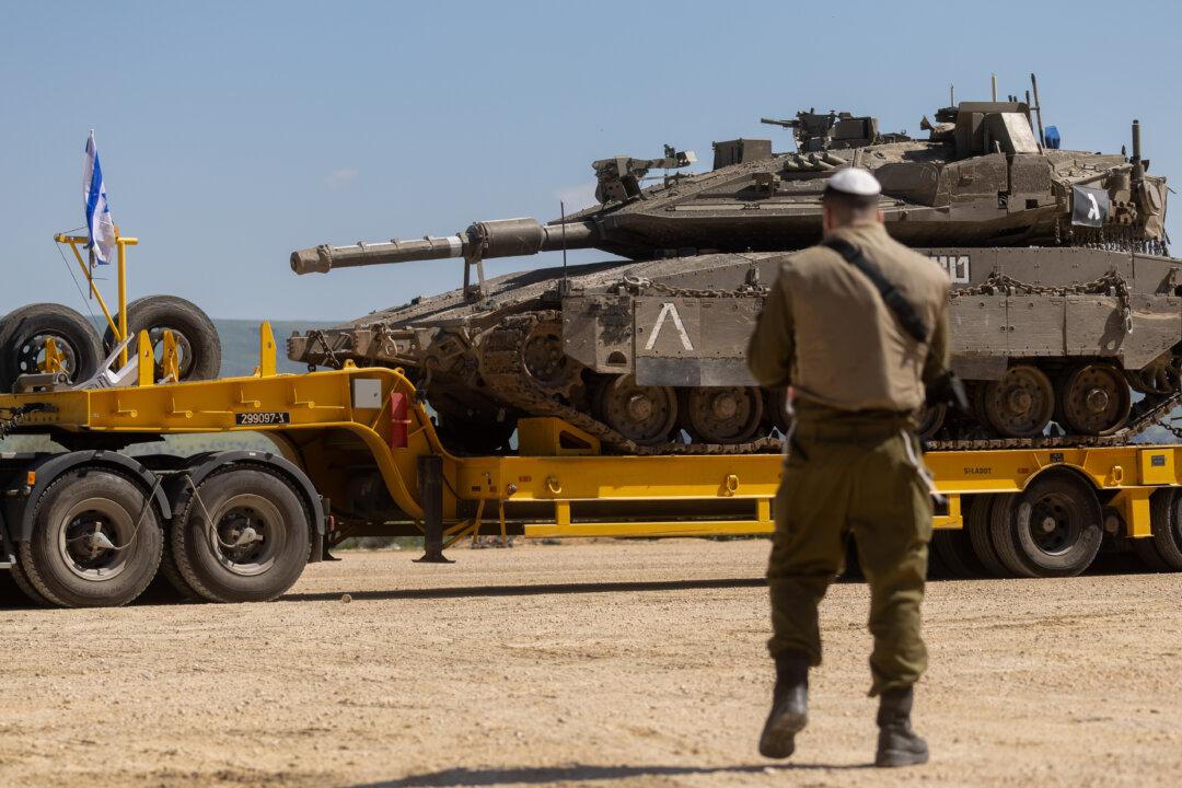 NORTHERN ISRAEL, ISRAEL - MARCH 5: An Israeli soldier stands near a truck carrying an Israeli tank near the border with Lebanon on March 5, 2026 in northern Israel. Hezbollah, the Iran-backed militant group in Lebanon, launched missiles at Israel in what it said was retaliation for the joint U.S.-Israeli war on Iran. (Photo by Amir Levy/Getty Images)