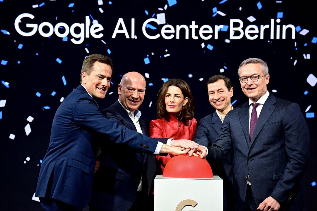 (L-R) Google Managing Director Germany and Vice President Central Europe Philipp Justus, Berlin's governing mayor Kai Wegner, the Google Vice-President of Government Affairs and Public Policy Annette Kroeber-Riel, the Vice-President, Research at Google DeepMind Slav Petrov and German Digital Minister Karsten Wildberger pose for the media to push the red button during the opening of a Google AI-Centre in Berlin on March 5, 2026. Google opens an AI centre in Berlin on March 5, 2026, the latest sign of Europe's deepening reliance on US firms in cutting edge technologies despite the continent's stated aim to catch up with its rivals. Germany's ministry for digital affairs told AFP the centre will bring together cloud computing and data infrastructure, "AI development" operations as well as a space for cooperation between start-ups and research centres. (Photo by Tobias SCHWARZ / AFP via Getty Images)